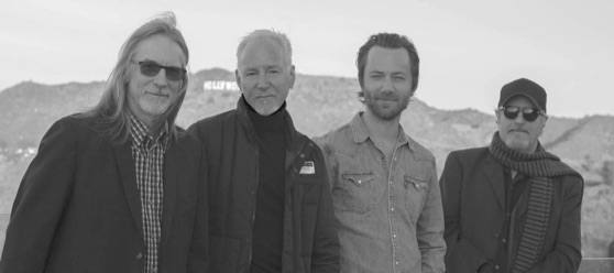 Jeff Kossack and the OtherHand, four musicians in black and white with the Hollywood sign behind them